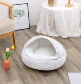 Cozy cat curled up in NestPet round plush bed